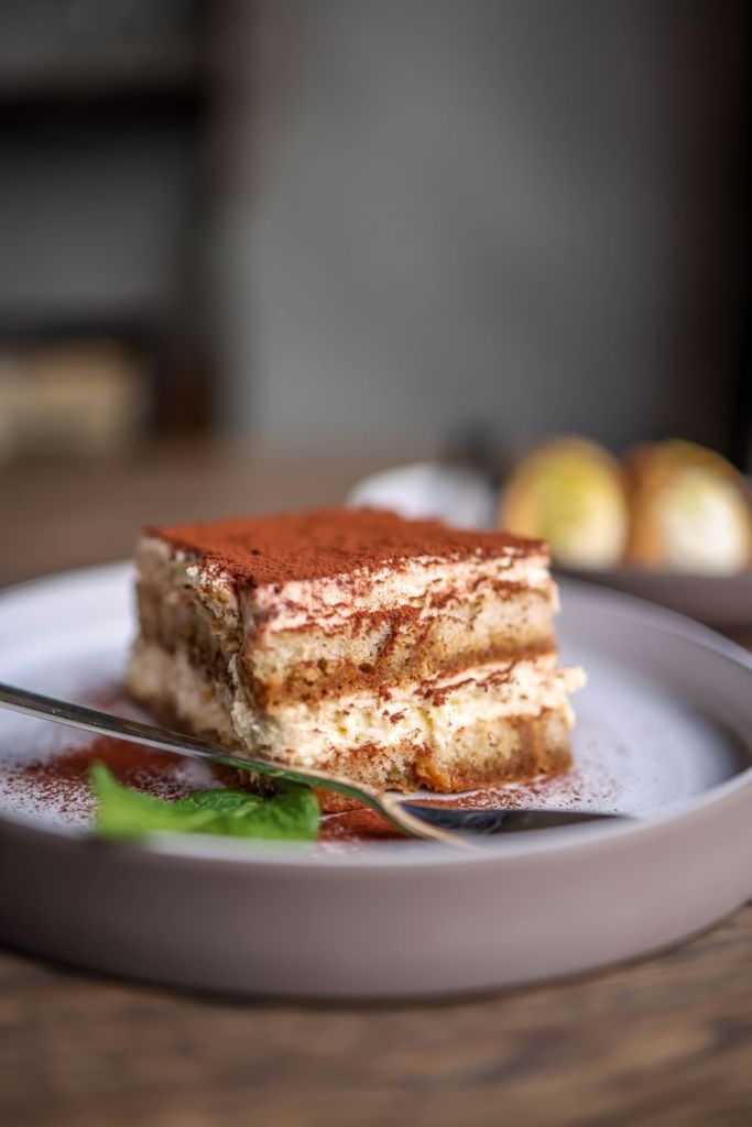 a slice of tiramisu on a plate with a fork